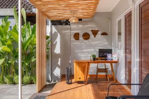 an office with a wooden desk on a patio at Cove Dahayu Sanctuary in Sanur