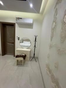 a bathroom with a sink and a fan on the wall at قوت in Abha +13 photos