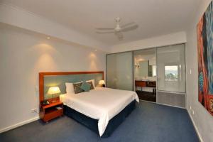 a bedroom with a large white bed and a window at Sea Side 209 in Mandurah