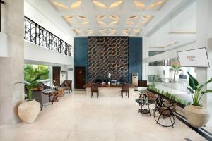 a lobby of a hotel with chairs and tables at 1O1 URBAN Heritage Yogyakarta Lynn Prawirotaman in Yogyakarta