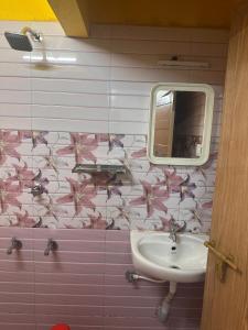 a bathroom with a sink and a mirror at MSP Amma Cottage in Munnar +35 photos