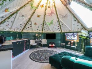 a living room with a ceiling with butterflies on it at Applejacks Orchard in Holywell