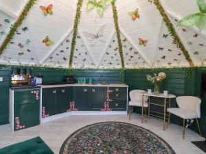 a room with green cabinets and butterflies on the ceiling at Applejacks Orchard in Holywell