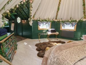 a bedroom with a bed in a green room at Applejacks Orchard in Holywell