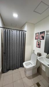 a bathroom with a toilet and a sink at Peppers Crib in Manila