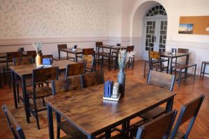 a dining room with wooden tables and chairs at CVJM Peregrinus Herberge in Görlitz +49 photos
