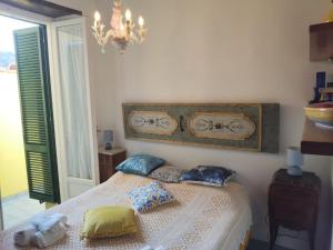 a bedroom with a bed with pillows on it at Di sole e d’azzurro - sea view in Gaeta