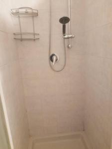 a bathroom with a shower with a tub and a toilet at Casa Pirandello 3 min Metro in Sesto San Giovanni +8 photos