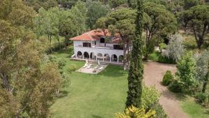 an aerial view of a house in the forest at Hacienda Beachfront Villa, Spathies in Nikiti