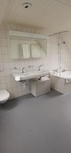 a bathroom with two sinks and a toilet at Apartment on 2 floors in Stäfa