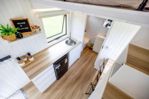 an overhead view of a tiny house kitchen with a sink at Echidna by Tiny Away in Thoopara
