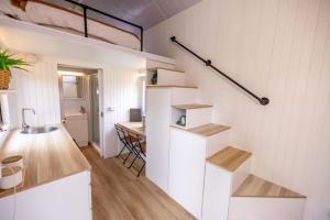 a kitchen with stairs and a table in a room at Echidna by Tiny Away in Thoopara +18 photos