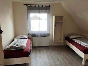 a small room with two beds and a window at Pension Highway - Bünde Carl Diem Straße 46 in Bünde