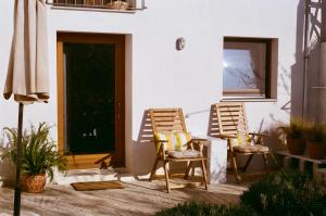 two chairs sitting on a patio next to a door at Apple Orchard Pelion in Volos