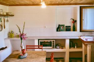 a kitchen with a toy doll sitting at a table at Apple Orchard Pelion in Volos