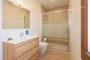 a bathroom with a toilet and a sink and a shower at Apartamentos Turísticos Olivares in Mota del Cuervo +31 photos