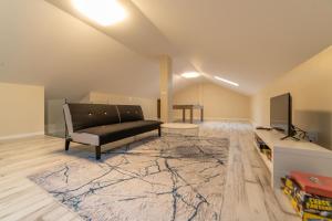 a living room with a couch and a flat screen tv at Villa Geranios in Belverde +43 photos