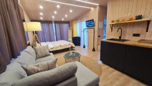 a living room with a couch and a bed at Jomas & Baltic beach in Jūrmala