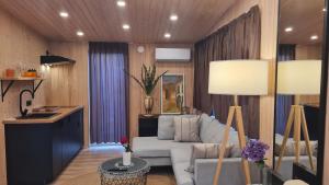 a living room with a white couch and two lamps at Jomas & Baltic beach in Jūrmala