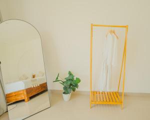 a mirror in a room with a dress on a rack at Star Hill Kintamani in Kubupenlokan +24 photos