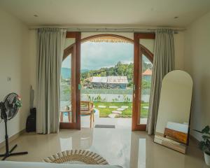 a living room with a large sliding glass door at Star Hill Kintamani in Kubupenlokan