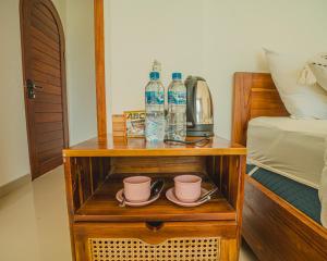 a night stand with two bottles of water and cups at Star Hill Kintamani in Kubupenlokan