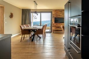 a kitchen and dining room with a table and chairs at UplandParcs Bergblick in Winterberg