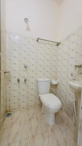 a bathroom with a toilet and a sink at Hotel Labbaik Three College Gate in Dhaka