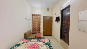 a small room with a bed and a door at Hotel Labbaik Three College Gate in Dhaka +44 photos