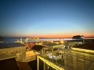 a view of a beach at night with a pier at Casa Molly in Follonica