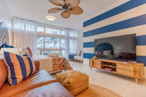a large living room with blue and white stripes at Alfomada in Umdloti