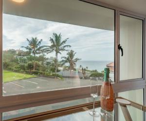 a window with a view of the ocean at Alfomada in Umdloti