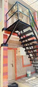 a metal staircase on the side of a building at ADwarkesh femily homestay in Dwarka