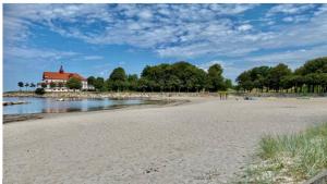 a beach with a house in the middle of the water at Fiskargränden, Landskrona in Landskrona