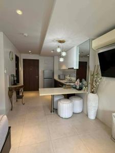 a large kitchen with a table and two stools at stevenplace at Tambuli in Maribago