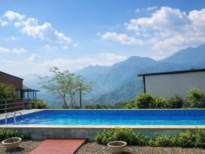 a swimming pool with mountains in the background at Sapa May Ecolodge in Sapa