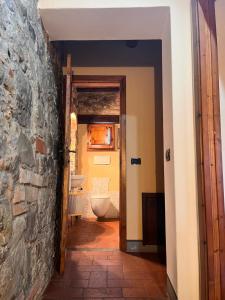 a hallway of a bathroom with a stone wall at W il silenzio! in Gualdo