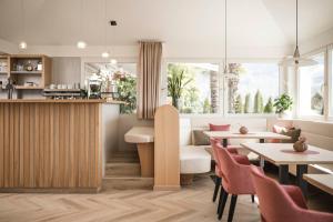 a restaurant with tables and chairs and a counter at Appartementhaus Residence Hirzer in Tirolo