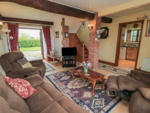 a living room with a couch and a coffee table at The Stables in Sturminster Newton