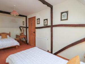 a bedroom with a white bed in a room at The Stables in Sturminster Newton