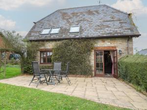 a table and chairs in front of a building at The Stables in Sturminster Newton