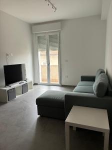 a living room with a couch and a tv at Biancamilla's Home in Giulianova