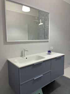 a bathroom with a sink and a mirror at Biancamilla's Home in Giulianova