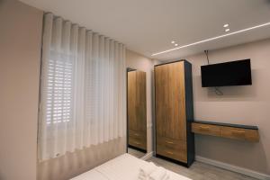 a bedroom with a bed and a tv and a window at STAR Hotel in Bathore