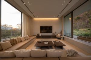 a living room with a large couch and a table at Number Three Pool Villa Khaoyai in Ban Tha Maprang