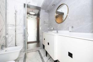 a white bathroom with a sink and a mirror at Happy Day Apartment, By Cohost in Palanga +49 photos