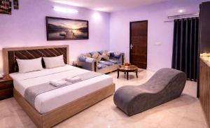 a bedroom with a bed and a chair in it at Hotel Comfort Inn, Nangloi, Walking from Metro in New Delhi