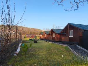 a row of cottages in a field with a yard at "La Aurel" Mahmudia in Mahmudia