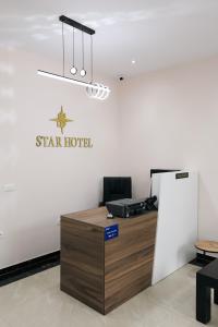 an office with a star hotel sign on the wall at STAR Hotel in Bathore