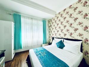a bedroom with a large bed and a window at Dalat Eco Hotel in Da Lat +57 photos
